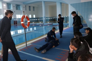 "Rescuing a drowning person and providing emergency first aid"